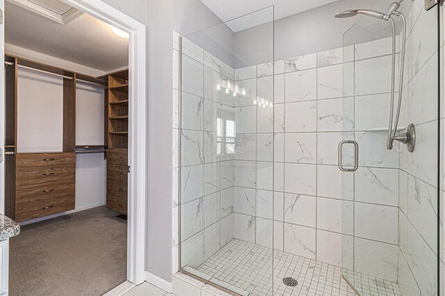 full bath featuring a stall shower and baseboards