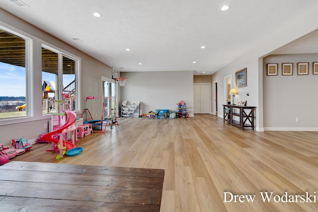 game room with recessed lighting, baseboards, and wood finished floors