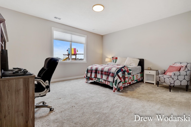 carpeted bedroom featuring visible vents and baseboards