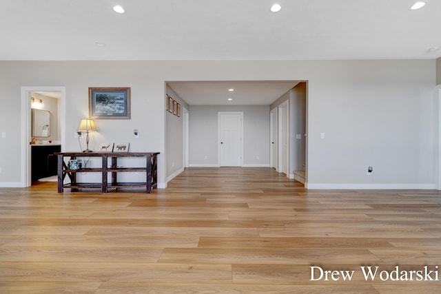 interior space featuring baseboards, recessed lighting, and light wood-style floors