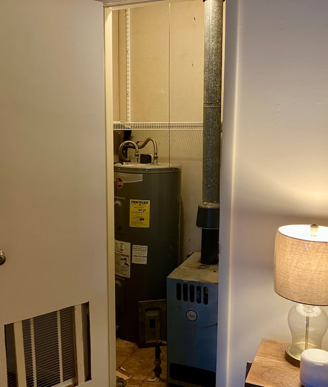 utility room featuring electric water heater