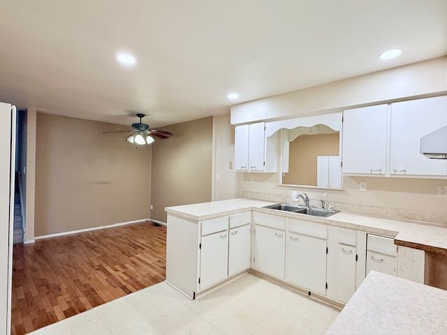 kitchen with recessed lighting, a sink, a ceiling fan, white cabinets, and light countertops