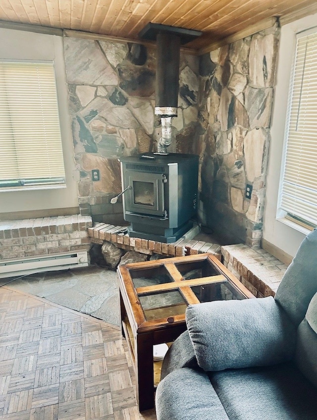 8530 Catherwood Dr, Goodrich, MI 48438 - interior space featuring a wood stove, a baseboard radiator, and wood ceiling