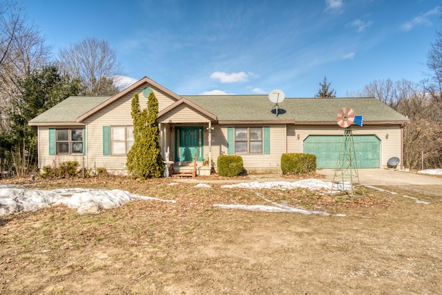 ranch-style house with concrete driveway and an attached garage