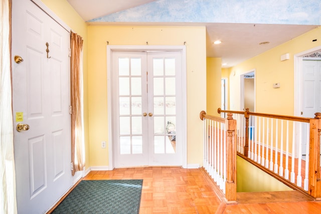 doorway to outside with lofted ceiling, french doors, recessed lighting, and baseboards