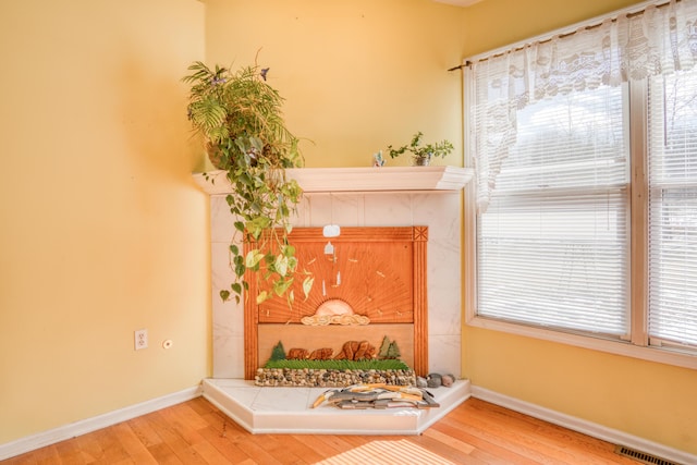 interior space featuring wood-type flooring, visible vents, and baseboards