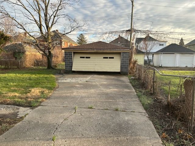 detached garage featuring fence