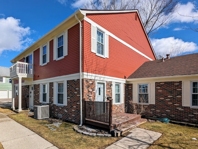 view of front of property with brick siding and cooling unit