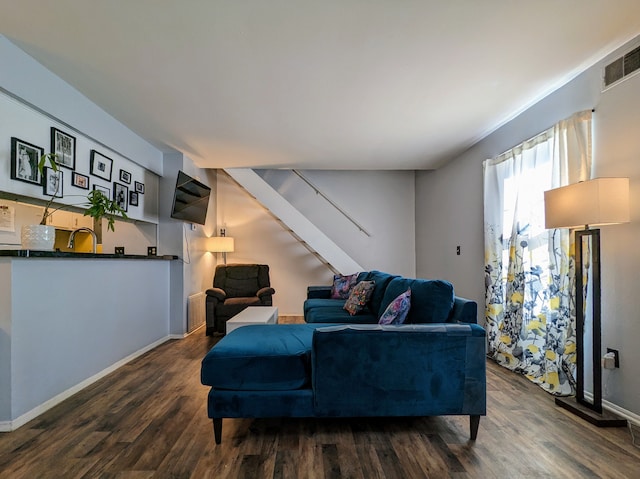 living area featuring dark wood-style floors, visible vents, stairway, and baseboards