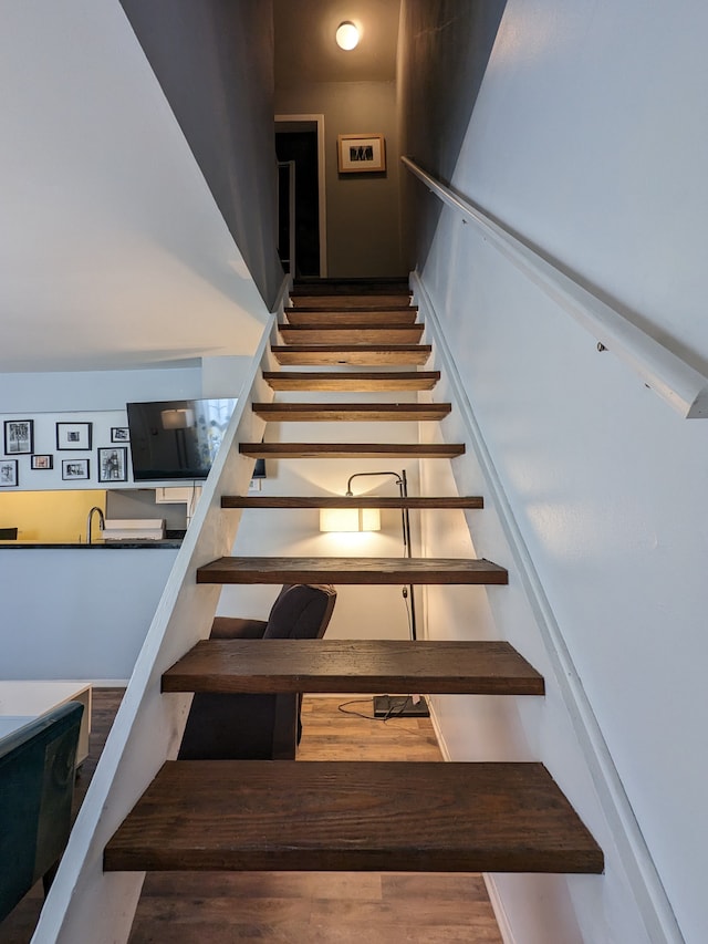 stairway with wood finished floors