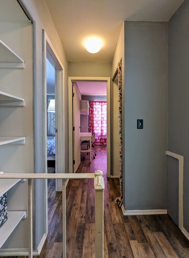 hall with wood finished floors and baseboards