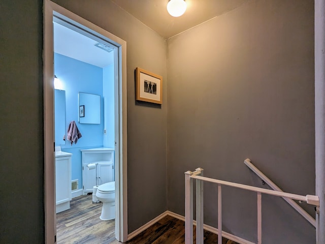 bathroom with visible vents, wood finished floors, toilet, and baseboards