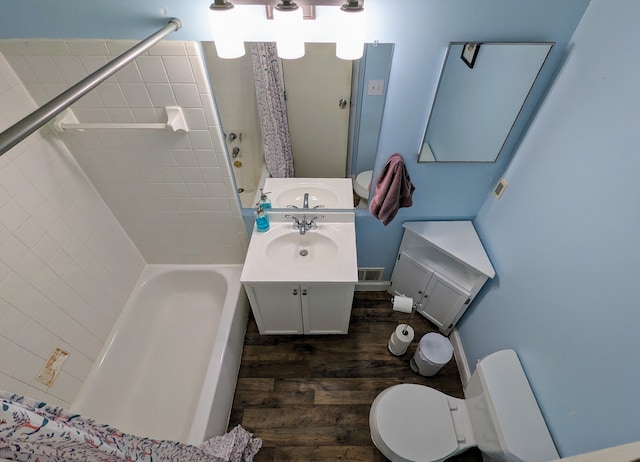 full bathroom featuring visible vents, toilet, wood finished floors, tub / shower combination, and vanity