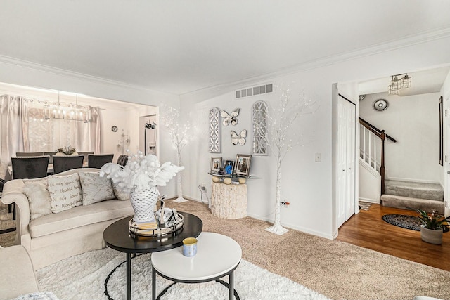 carpeted living room featuring ornamental molding, visible vents, stairway, and baseboards