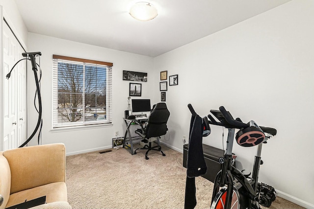 carpeted home office with visible vents and baseboards