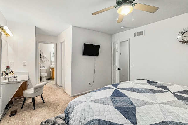 bedroom with light carpet, ceiling fan, visible vents, and ensuite bathroom