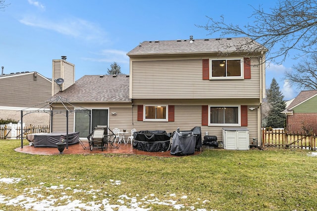 back of property featuring a yard, a patio area, and fence