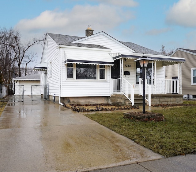 bungalow featuring a porch, roof with shingles, a chimney, and a front lawn