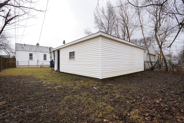 back of house with a fenced backyard and a lawn