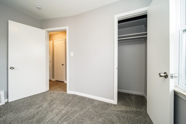 unfurnished bedroom with carpet, a closet, visible vents, and baseboards