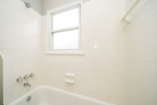 bathroom featuring a shower and a bath