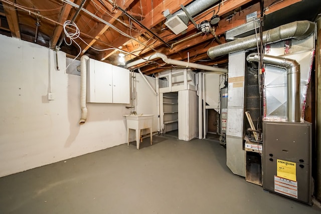 unfinished basement with water heater and visible vents