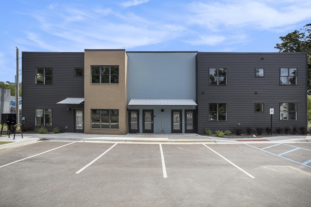 view of building exterior featuring uncovered parking