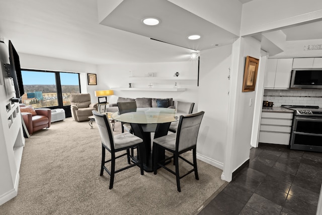 dining area featuring dark colored carpet, recessed lighting, and baseboards