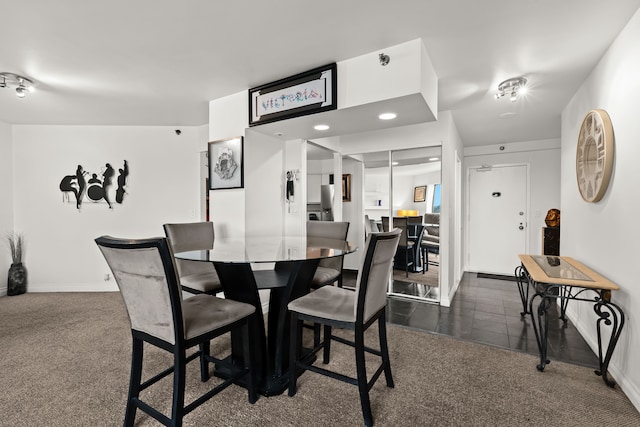 dining room with baseboards, dark carpet, and recessed lighting