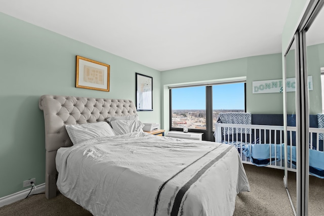 bedroom with carpet floors and baseboards