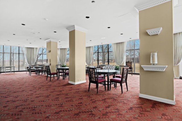 dining area featuring expansive windows, baseboards, and carpet flooring