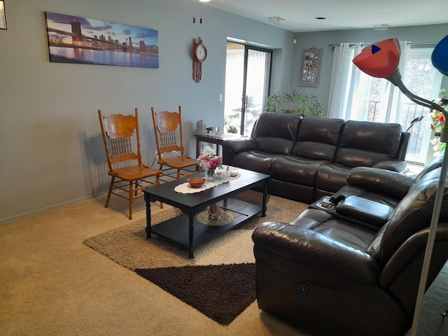 carpeted living area with baseboards