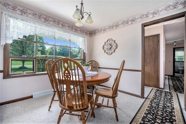 dining area with baseboard heating, baseboards, and an inviting chandelier