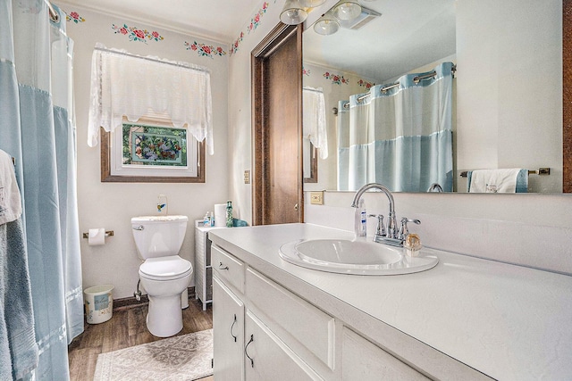 full bath with toilet, a shower with curtain, wood finished floors, and vanity