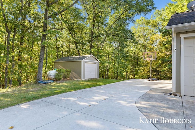 view of patio / terrace featuring an outdoor structure and a detached garage