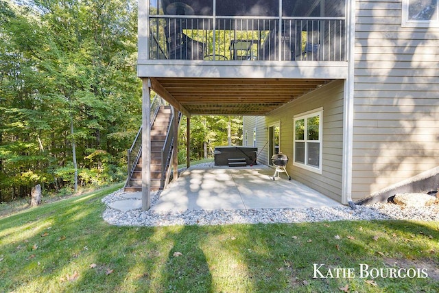 view of patio / terrace with a hot tub, a grill, and stairway