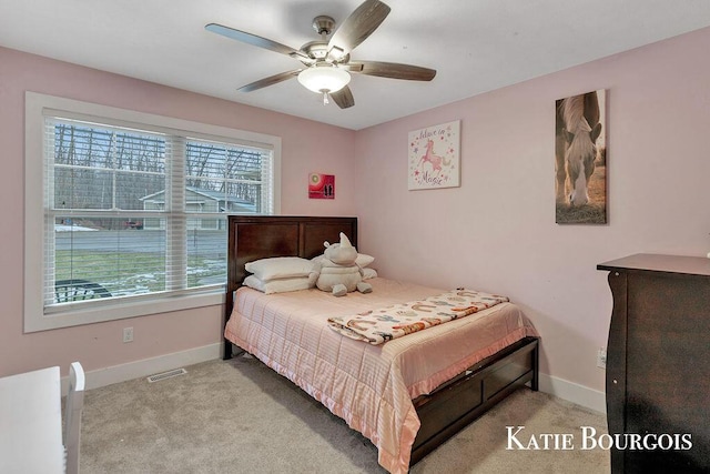 carpeted bedroom with ceiling fan and baseboards