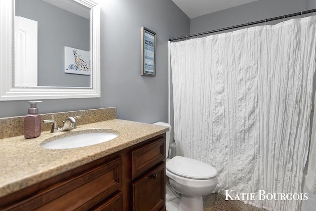 bathroom with toilet, vanity, and a shower with curtain