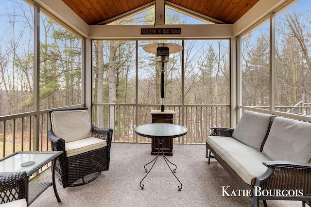 sunroom / solarium featuring wood ceiling and vaulted ceiling