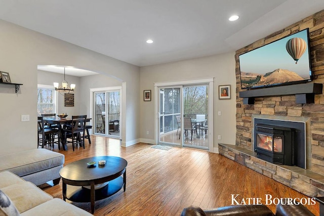 living area with a wealth of natural light, recessed lighting, baseboards, and hardwood / wood-style flooring