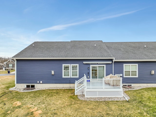 rear view of property with roof with shingles, a lawn, and a wooden deck