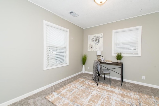 office with ornamental molding, carpet flooring, visible vents, and baseboards