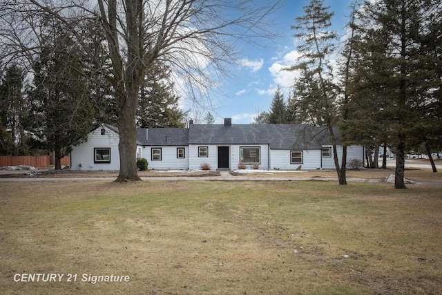 ranch-style home with fence and a front yard