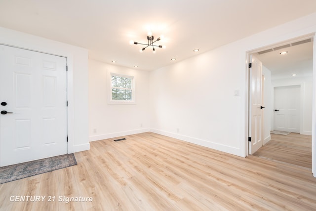 unfurnished room with recessed lighting, visible vents, light wood-style flooring, and baseboards