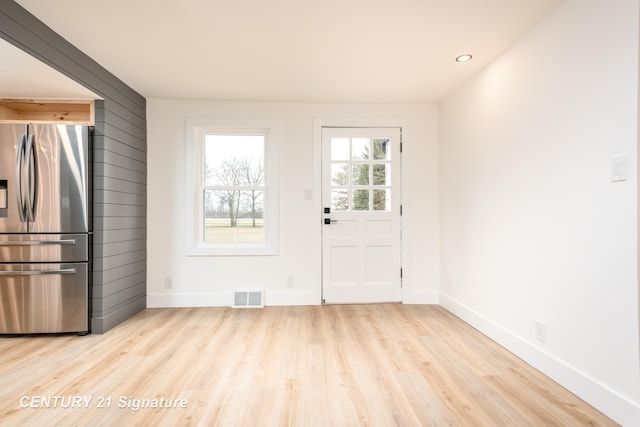 doorway with recessed lighting, wood finished floors, visible vents, and baseboards