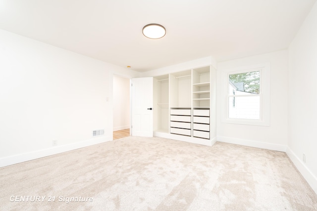 unfurnished bedroom with baseboards, visible vents, and carpet flooring