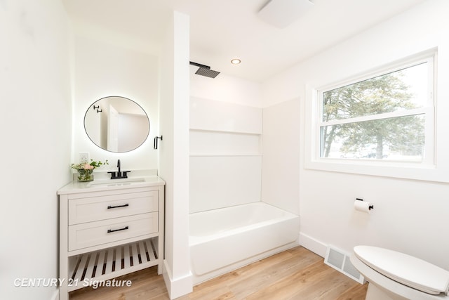 full bath with visible vents, toilet, vanity, wood finished floors, and baseboards