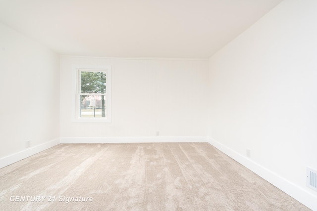 unfurnished room with baseboards and carpet flooring