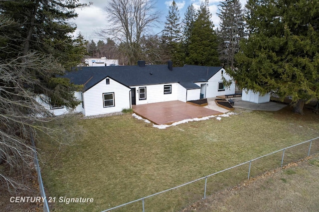 back of property featuring a lawn, a patio area, and fence