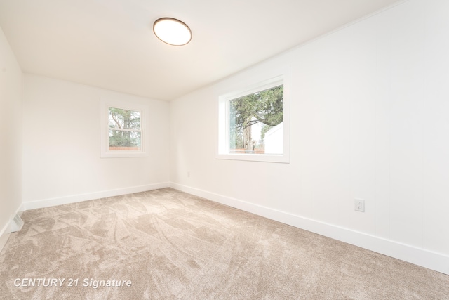 carpeted spare room with baseboards